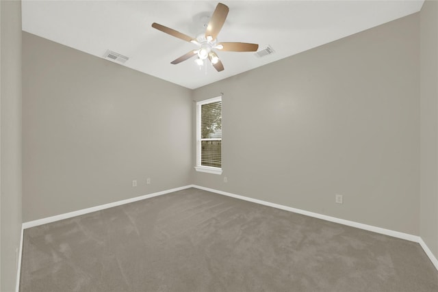 spare room featuring ceiling fan and carpet