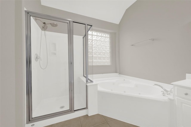 bathroom with tile patterned flooring, separate shower and tub, and lofted ceiling