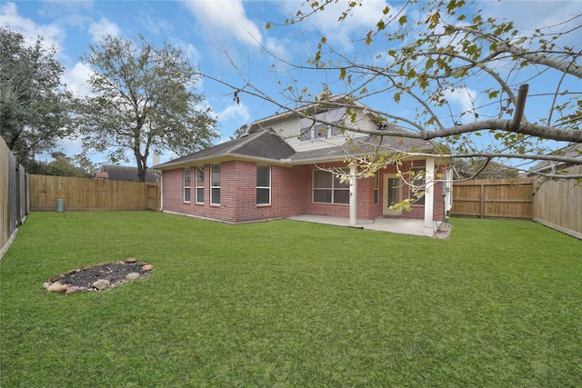 back of property with a lawn and a patio area