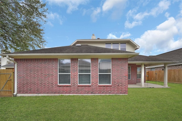 rear view of property featuring a patio area and a yard