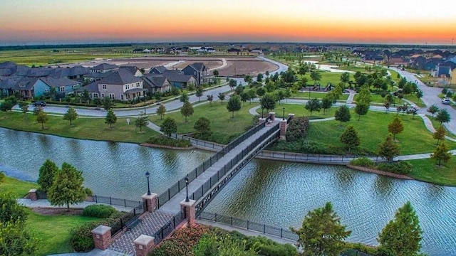 aerial view at dusk with a water view