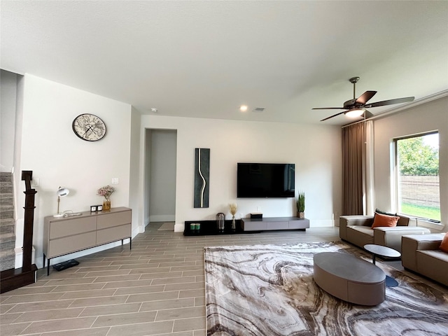 living room featuring ceiling fan and light hardwood / wood-style flooring