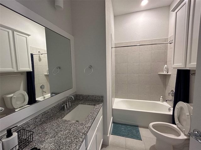 full bathroom featuring toilet, tile patterned flooring, tile walls, tiled shower / bath, and vanity