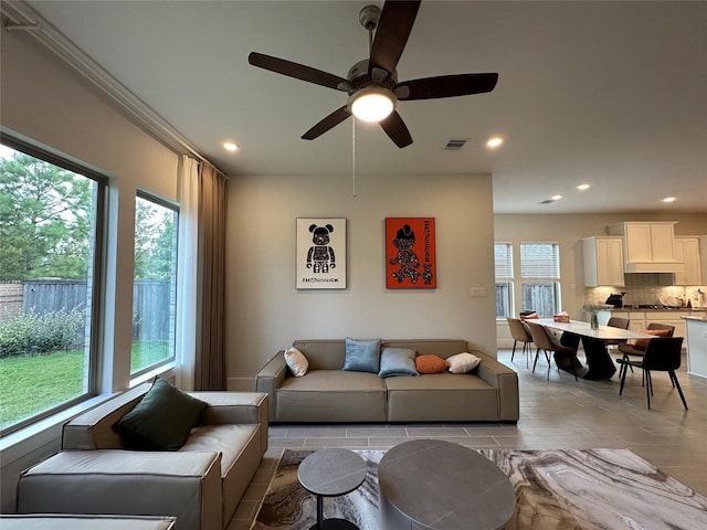 living room with ceiling fan and light hardwood / wood-style flooring