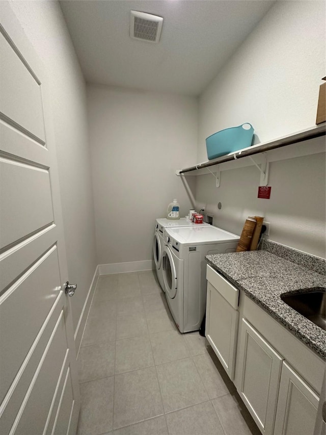 laundry area featuring sink, cabinets, and independent washer and dryer