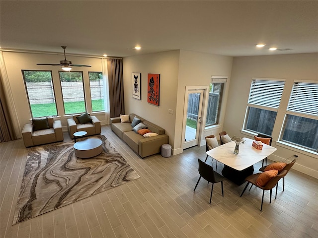 living room with light wood-type flooring and ceiling fan