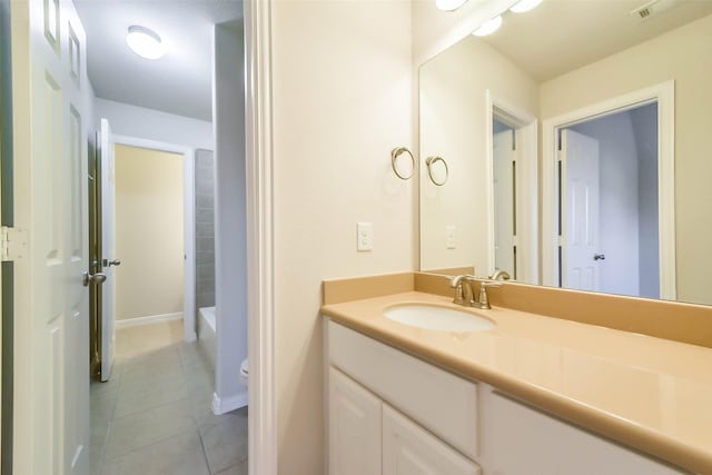 bathroom featuring tile patterned flooring, vanity, and toilet