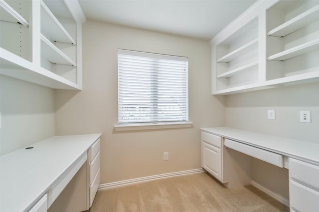 unfurnished office featuring light carpet and built in desk