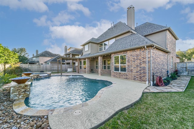 view of swimming pool with a patio area, an in ground hot tub, a yard, and pool water feature