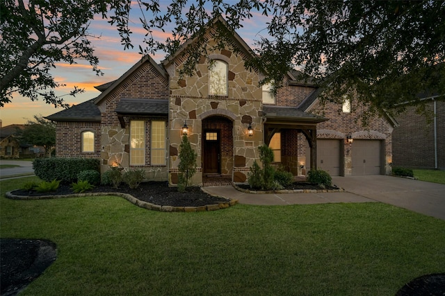 view of front of property with a yard and a garage