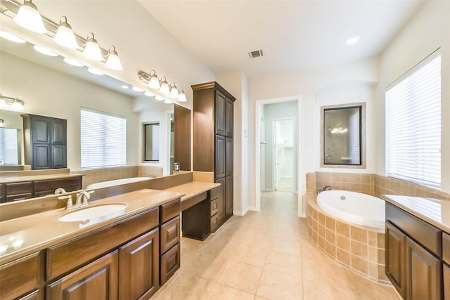 bathroom with tile patterned flooring, vanity, and a healthy amount of sunlight