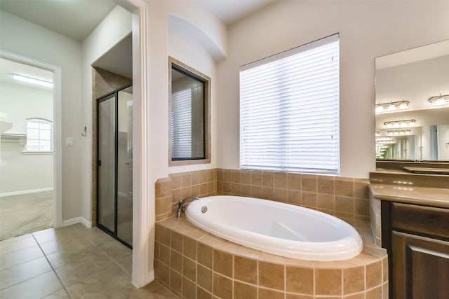 bathroom featuring plus walk in shower, tile patterned flooring, and vanity