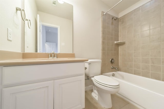 full bathroom featuring tile patterned flooring, vanity, tiled shower / bath combo, and toilet