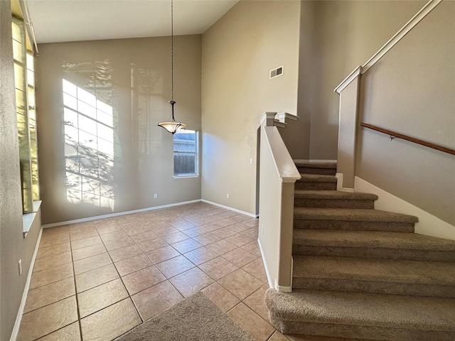 stairway with tile patterned flooring