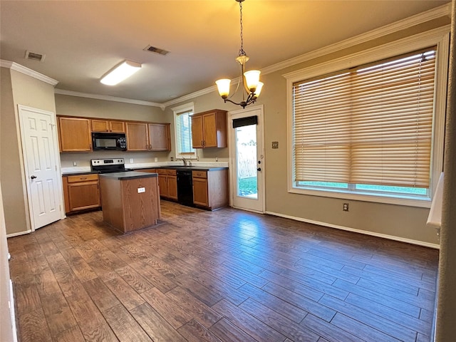 kitchen featuring a notable chandelier, black appliances, ornamental molding, decorative light fixtures, and a kitchen island