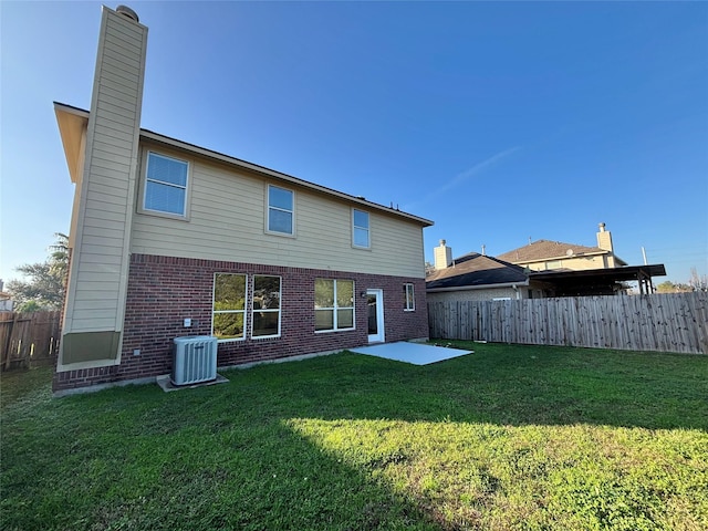 back of house with a yard, cooling unit, and a patio