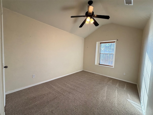 spare room featuring ceiling fan, carpet, and vaulted ceiling