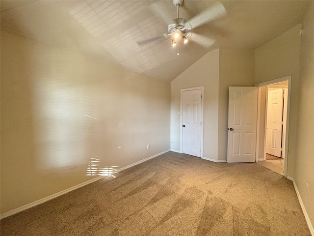 unfurnished bedroom with carpet flooring, ceiling fan, and high vaulted ceiling