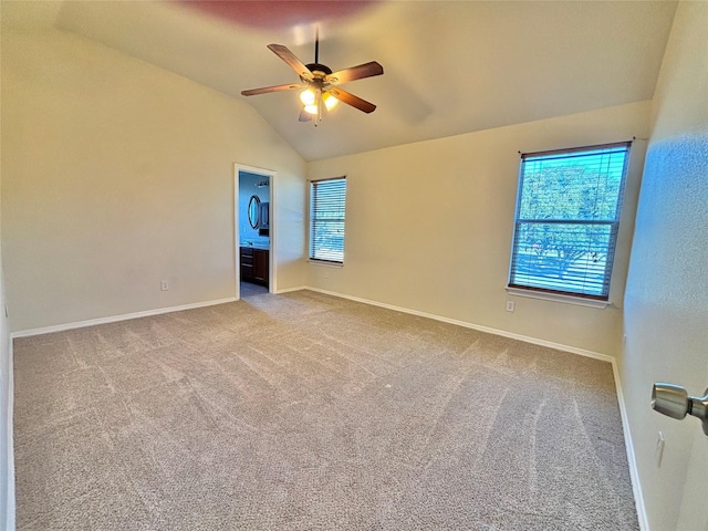 unfurnished room featuring carpet, ceiling fan, lofted ceiling, and a wealth of natural light