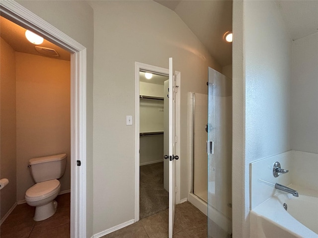 bathroom featuring tile patterned flooring, separate shower and tub, toilet, and vaulted ceiling