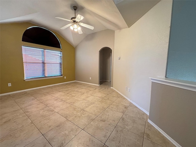 tiled spare room with ceiling fan and vaulted ceiling