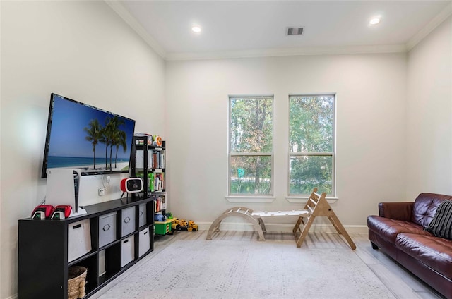 recreation room with crown molding and hardwood / wood-style floors