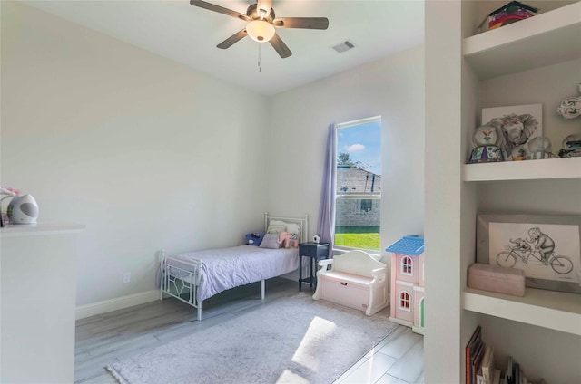 bedroom with light hardwood / wood-style floors and ceiling fan