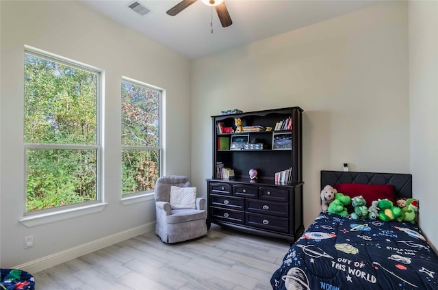 bedroom featuring multiple windows, light hardwood / wood-style flooring, and ceiling fan