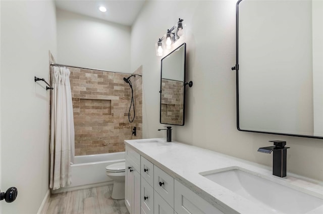 full bathroom with shower / tub combo with curtain, vanity, and toilet