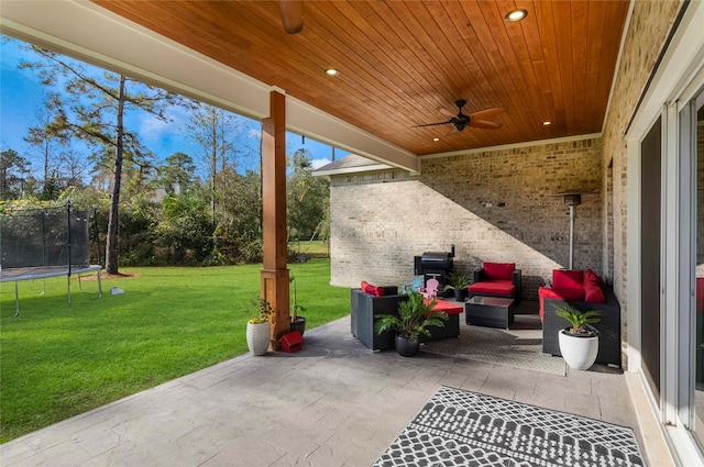 view of patio / terrace with an outdoor living space, a trampoline, and ceiling fan