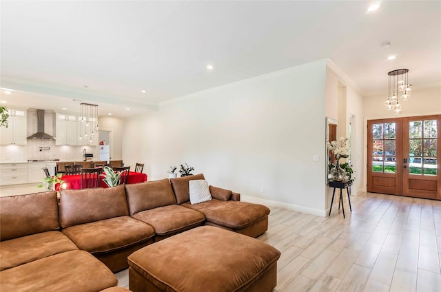 living room featuring french doors, light hardwood / wood-style flooring, and ornamental molding