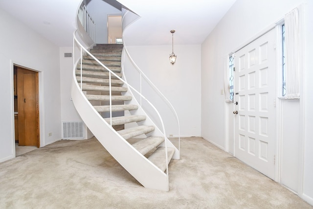 view of carpeted foyer entrance