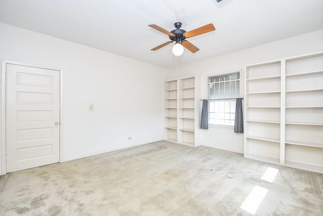 interior space with carpet floors and ceiling fan