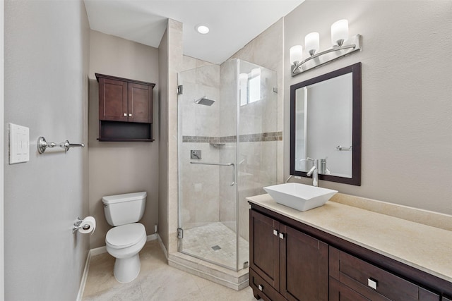 bathroom featuring vanity, toilet, and a shower with shower door