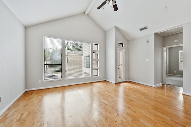 empty room featuring vaulted ceiling with beams, ceiling fan, and light hardwood / wood-style floors