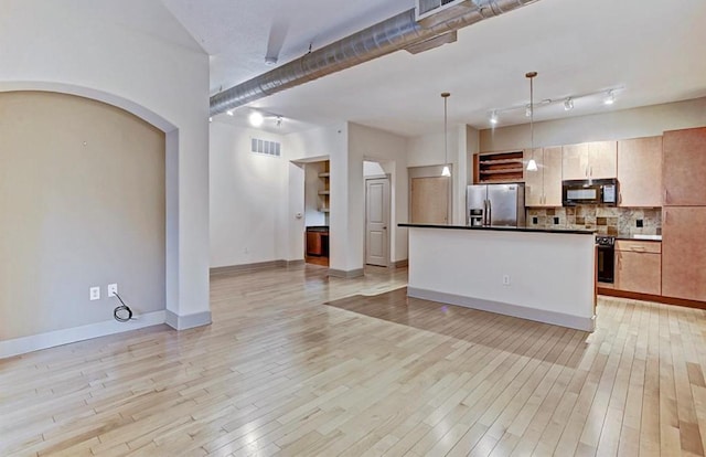 kitchen with stainless steel refrigerator with ice dispenser, backsplash, pendant lighting, light hardwood / wood-style flooring, and a kitchen island