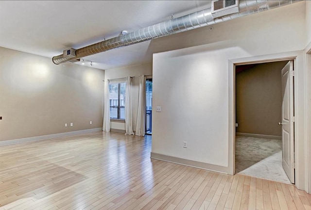 spare room with light hardwood / wood-style flooring