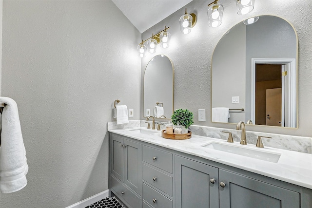 bathroom featuring vanity and lofted ceiling