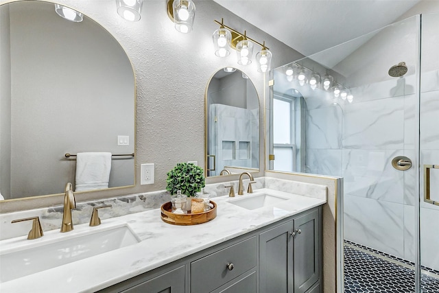 bathroom with vanity and a shower with door