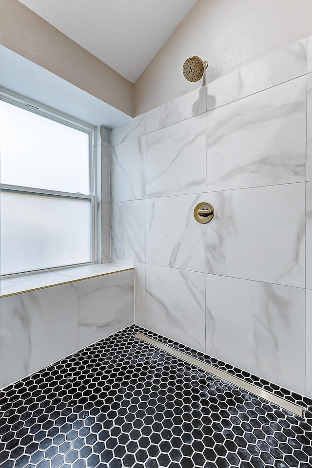 bathroom with a tile shower