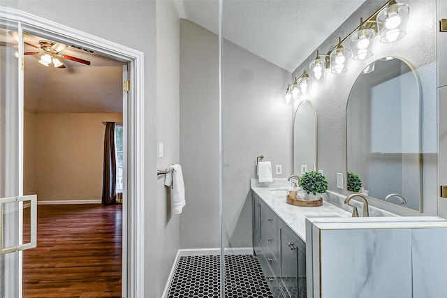 bathroom featuring vanity, ceiling fan, and lofted ceiling