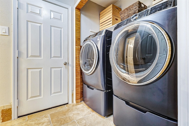 clothes washing area with washer and clothes dryer