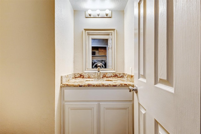 bathroom with vanity and a textured ceiling