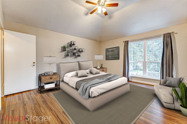 bedroom featuring wood-type flooring, ceiling fan, and lofted ceiling