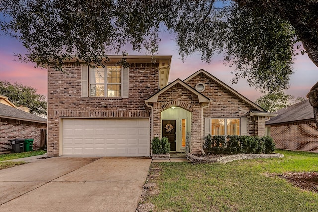 view of front of property with a yard and a garage