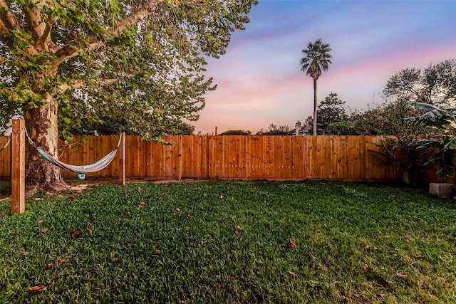 view of yard at dusk