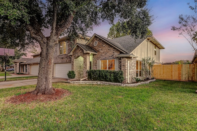 view of front of home with a garage and a yard