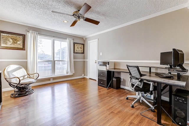 office space with ceiling fan, light wood-type flooring, a textured ceiling, and ornamental molding