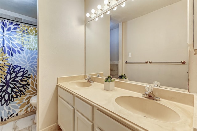 bathroom featuring vanity and toilet