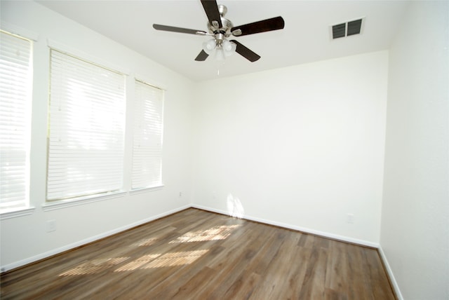 empty room featuring dark hardwood / wood-style floors and ceiling fan